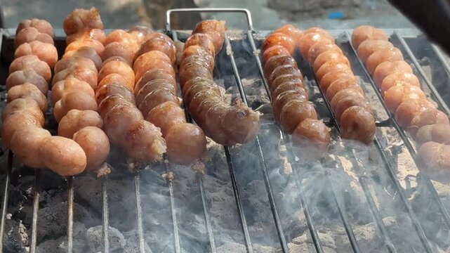 Thai Street Food Sausage Balls Cooking over Hot Coals