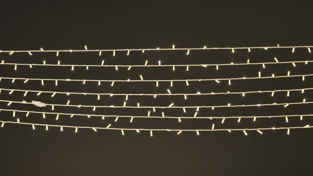 Warm led string lights creating rows of glowing decoration on dark background