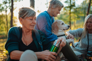Fototapeta premium Elderly female friendship drinking coffee in nature.
