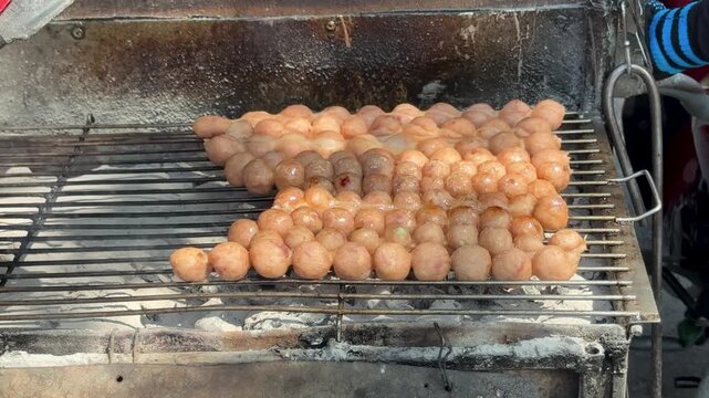 Thai Street Food Sausage Balls Cooking over Hot Coals
