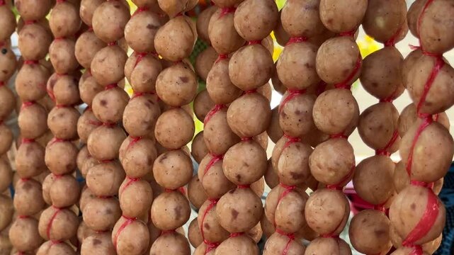 Thai Street Food Sausage Balls Hanging on a Street Food Cart