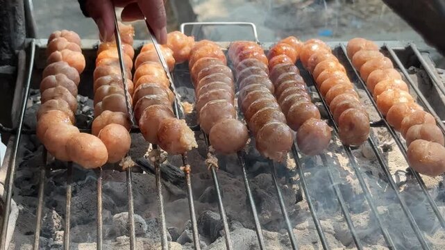 Thai Street Food Sausage Balls Cooking over Hot Coals