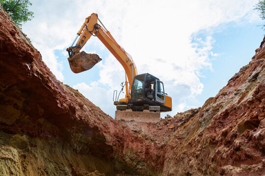 Excavator digging a trench for the pipeline.