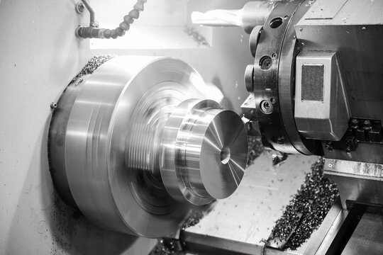 CNC lathe processes metal part.