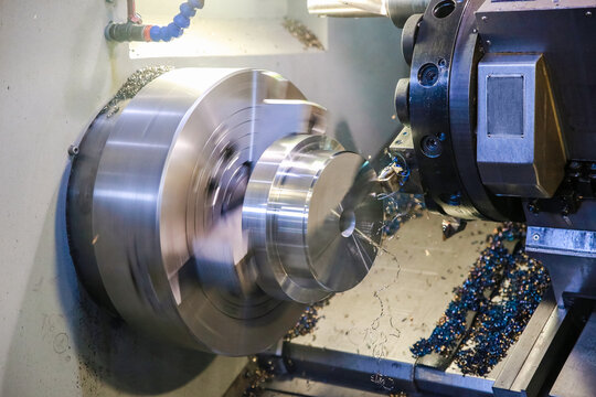 CNC lathe processes metal detail.