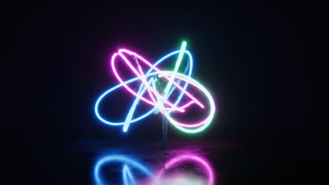 Vibrant neon light streaks form an abstract atomic orbital pattern against a dark, reflective surface, creating a dynamic and luminous visual representation of energy and motion