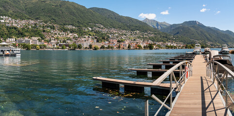 Naklejka premium Panoramic view of the city of Locarno from the pier on the shores of Lake Maggiore in Ticino, Switzerland.