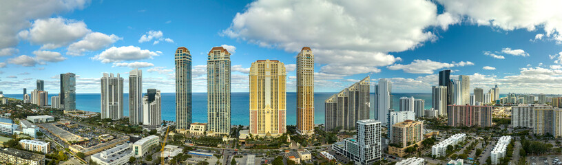Naklejka premium Aerial view of Sunny Isles Beach city with luxurious highrise hotels and condos on Atlantic ocean shore. American tourism infrastructure in southern Florida