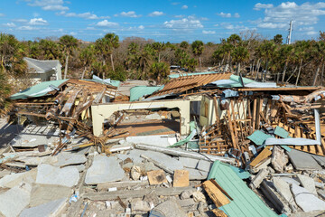 Fototapeta premium Destroyed house on ocean shore. Hurricane Milton consequences on Manasota Key, Florida. Storm surge severe damage