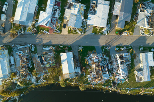 Destroyed by hurricane strong winds suburban houses in Florida mobile home residential area. Consequences of natural disaster