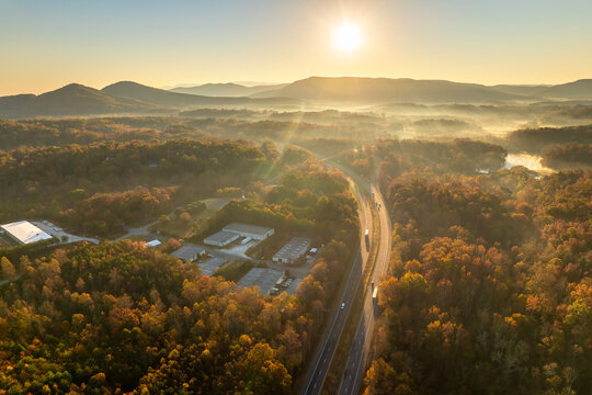 Highway road in North Carolina Appalachian mountains in fall season. Expressway lanes for fast passing of car traffic