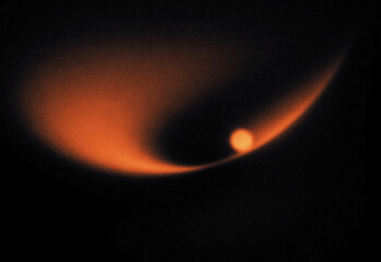 Fototapeta premium Abstract cosmic background with glowing orange nebula, light streaks and stardust texture