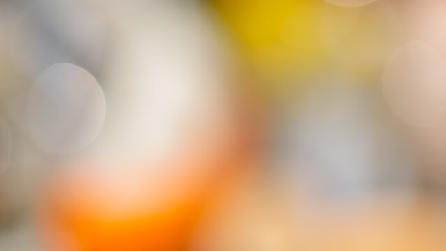 Warm abstract bokeh background with orange yellow and gray blurred circular light spots