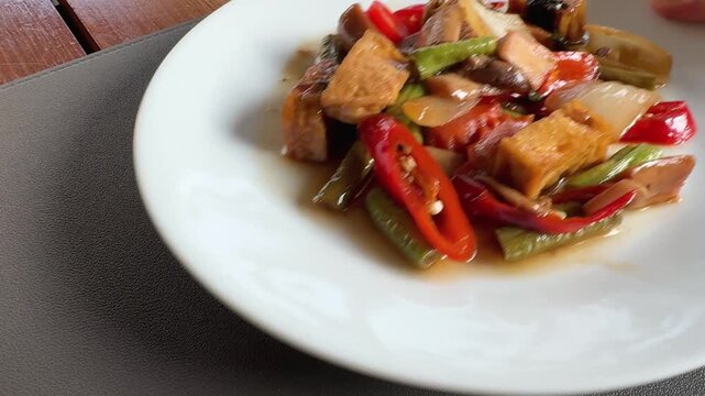 Serving a Plate of Spicy Thai Chili Tofu Stir Fry