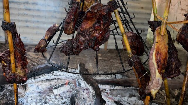 Traditional carne a la llanera cooking over embers