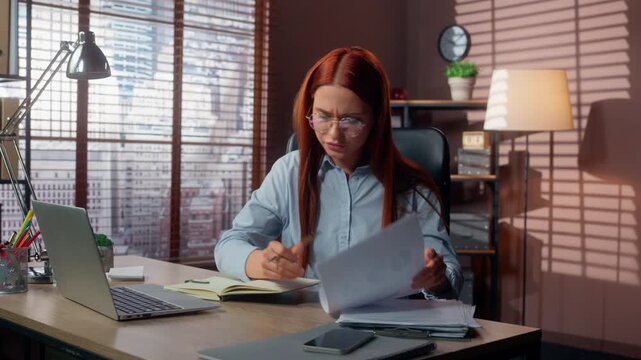 Caucasian business woman feeling stress writing notes analyzing stats using laptop feel panic in office businesswoman female executive stressed girl write analyze diagrams documents overloaded work