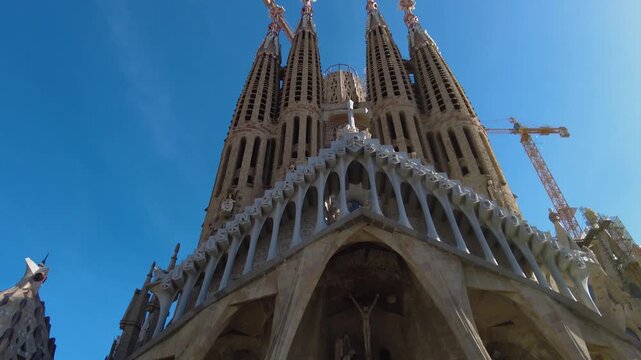 Street view around the downtown and the cathedral sagrada familia of the capitol city Barcelona, on a sunny spring day. With view from top of a bus