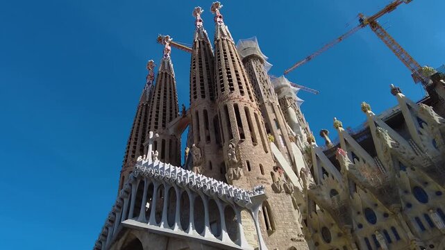 Street view around the downtown and the cathedral sagrada familia of the capitol city Barcelona, on a sunny spring day. With view from top of a bus