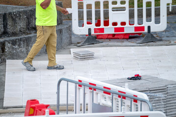 Naklejka premium Worker walking on new pavement tiles The Concept of urban development