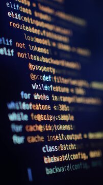 Python source code displayed on a developer's monitor with syntax highlighting. Close-up Vertical.