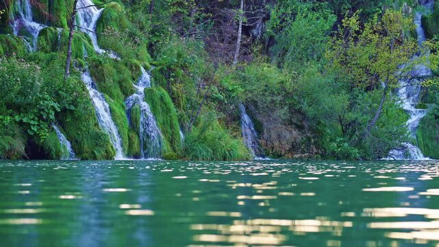 Nature with peaceful waterfall. Scenic landscape with cascading waterfalls. Crystal-clear lake reflects the beauty waterfall. Plitvice Lakes nature paradise. Nature harmony in a tranquil waterfall