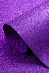 Obraz premium Elegant purple glitter paper mockup with a smooth curved roll layer, featuring a vibrant shimmering texture ideal for luxury holiday and craft designs