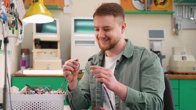 Skilled optician fixing eyeglasses in optical workshop