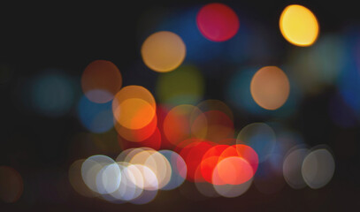 Fototapeta premium Colorful bokeh orange red pink yellow circle overlay on dark background