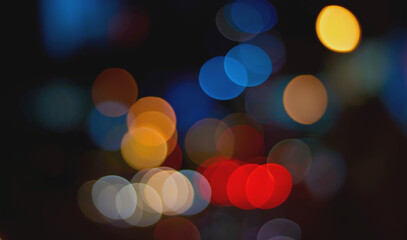 Fototapeta premium Colorful blue orange red bokeh overlay on dark night background photography