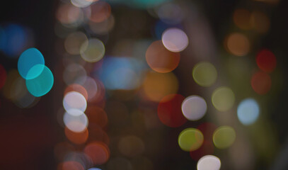 Fototapeta premium Multicolor bokeh circle overlay on dark background with teal orange green red
