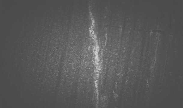 Dark black wood grain surface texture with faint white streak and scratch