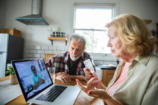 Senior couple discussing medication during telemedicine visit at home