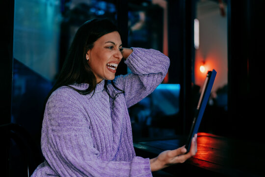 Close up of smiling woman looking at tablet screen. Digital banking, mobile payment, online shopping or social media interaction. Tech savvy user enjoying high speed internet connection, 5G web.