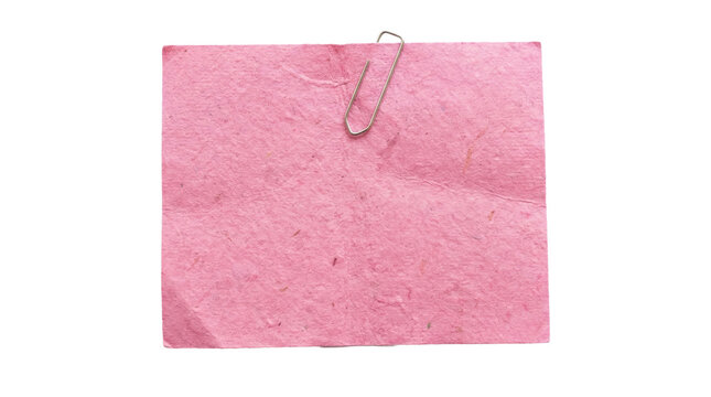 Square piece of pink handmade recycled paper with textured fibers and a metal paper clip isolated on transparent background. Eco friendly stationery and note concept