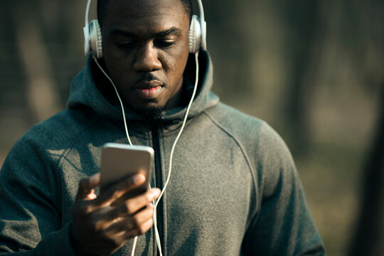 Man listening to music on smartphone in park