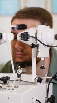 Ophthalmologist checking patient's eyesight using synoptophore machine
