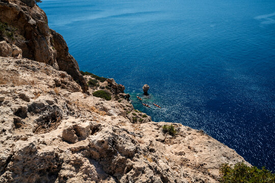 Rocky Cliff and Kayaks on Mediterranean Coast in Greece