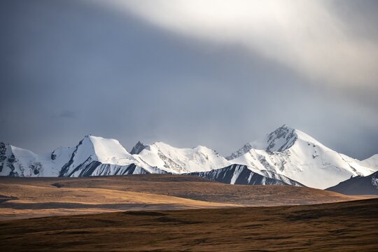 Glaciated and snow-capped mountains, dramatic landscape, high plateau, autumnal mountain landscape with yellow grass, Tian Shan, Sky Mountains, Sary Jaz Valley, Kyrgyzstan