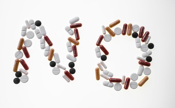 Colourful pills, tablets form the word No, symbolic picture addiction and drug abuse, background white, Germany, Germany