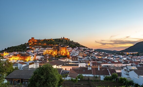 Town view of the village Aracena with illuminated fortress Castillo de Aracena, evening mood, Aracena, Huelva, Spain