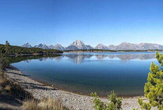 Mountains reflected in the lake, Jackson Lake, summit of Mount Moran with Teton Range mountain range, Grand Teton National Park, Wyoming, USA