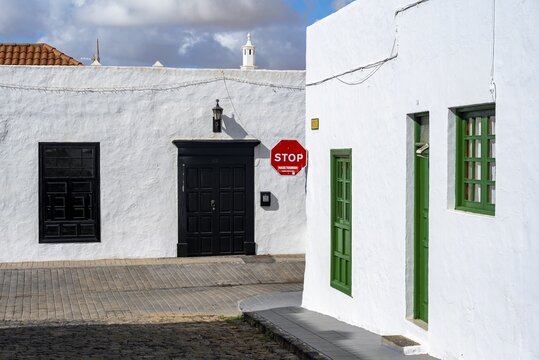 Typical white houses with colored doors and windows in an alley, Teguise, Lanzarote, Canary Islands, Spain