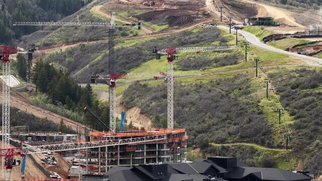 Aerial zoom shot of cranes and construction in Heber Valley Utah in spring
