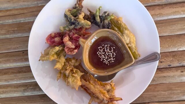 Rotating Plate of Deep Fried Tempura Battered Flower Blossoms and Dipping Sauce