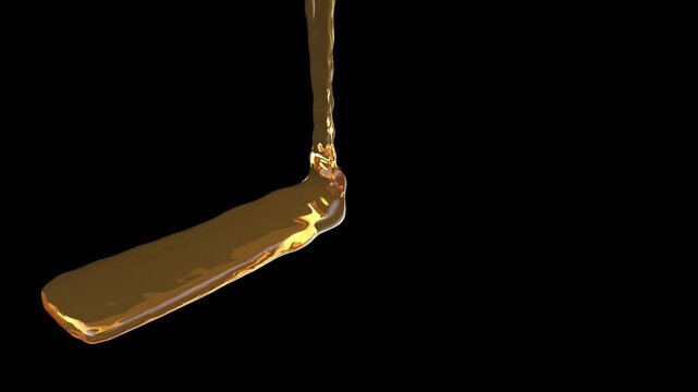 a stream of liquid chocolate pouring down on a flat surface