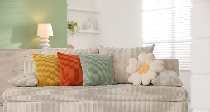 Colorful pillows on soft sofa indoors. Interior design