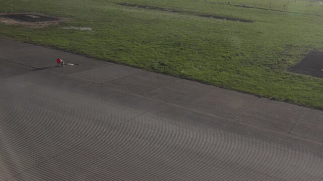 Inspection of runway surface with maintenance equipment at an airport in sunny weather