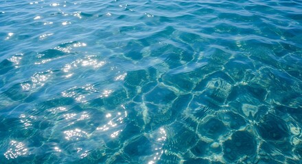 Fototapeta premium Ocean waves with sunlight sparkle and water ripples background for travel, sustainability, and environmental awareness marketing