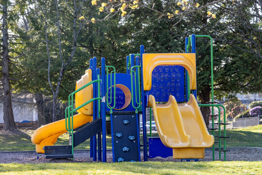 Colorful Children's Playground With Yellow Slides and Climbing Playset in Burnaby Park, Vancouver BC Canada