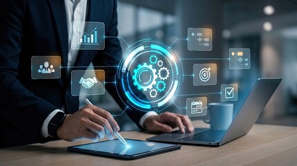 Fototapeta premium Executive using tablet and laptop with glowing gear mechanism and business icons overlay.